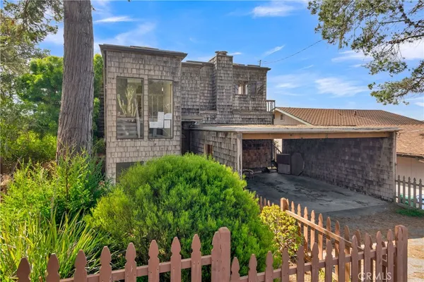 a view of a patio with table and chairs and wooden fence