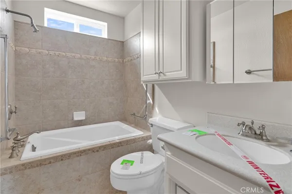 a bathroom with a granite countertop bathtub and a sink