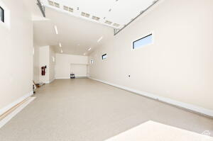1141 East Lost Ridge Drive Washington, UT 84780 - Photo 25 of 108 Spacious garage with light-colored flooring, white walls, and multiple windows providing natural illumination