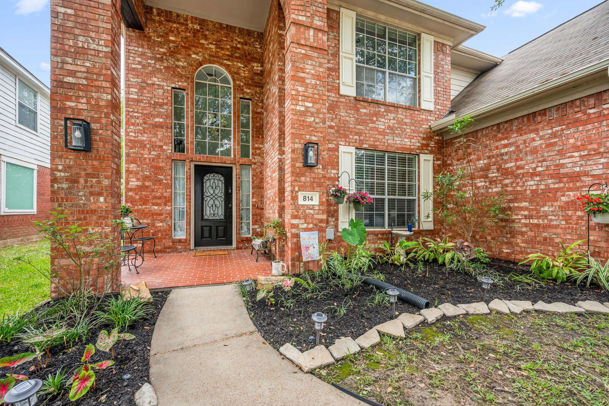 814 Legend Spring Drive Katy, TX 77494 - Photo 3 of 30 Fresh mulch and a seasonal refresh to the exterior of this home set the tone from the curb The brick front porch provides an elevated spot to welcome guests or receive deliveries in any weather. Sprinklers help keep your landscaping vital through the spring and summer months.