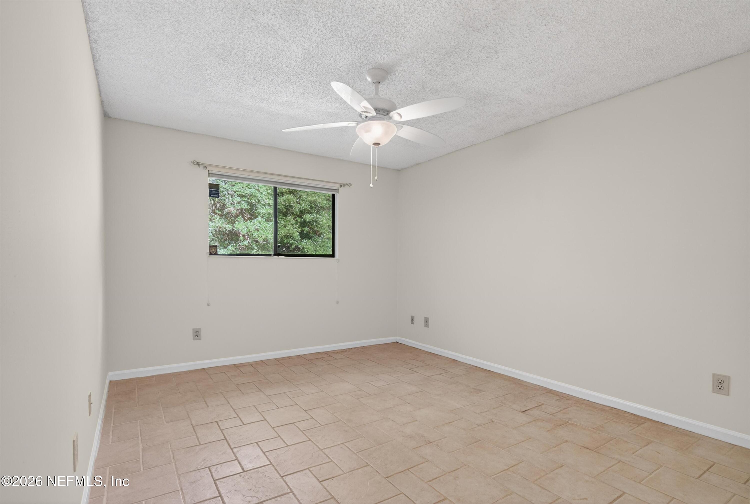 3801 Crown Point Road, Unit 1294 Jacksonville, FL 32257 - Photo 15 of 21 an empty room with a window and ceiling fan