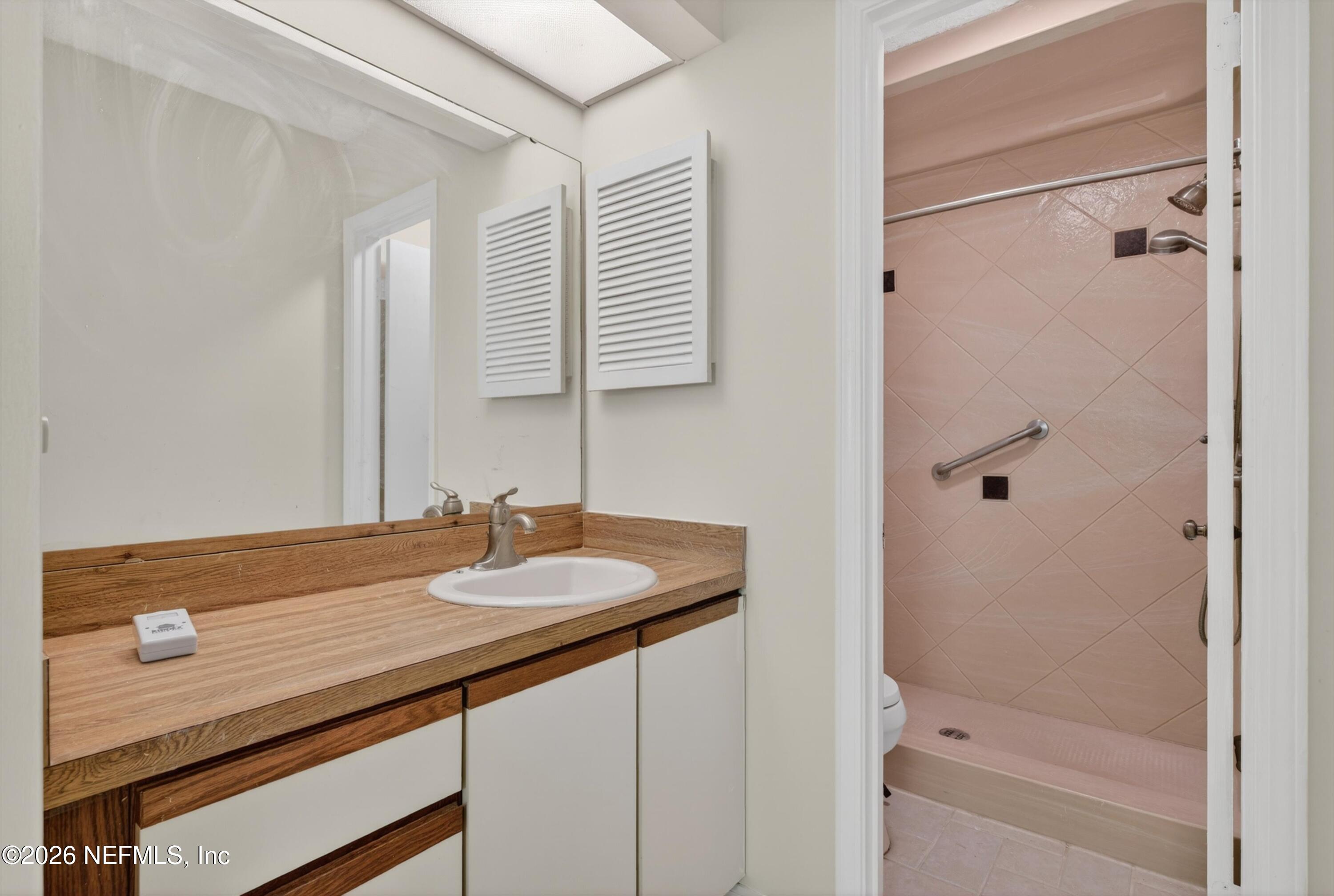 3801 Crown Point Road, Unit 1294 Jacksonville, FL 32257 - Photo 16 of 21 a bathroom with a granite countertop sink mirror and a bathtub