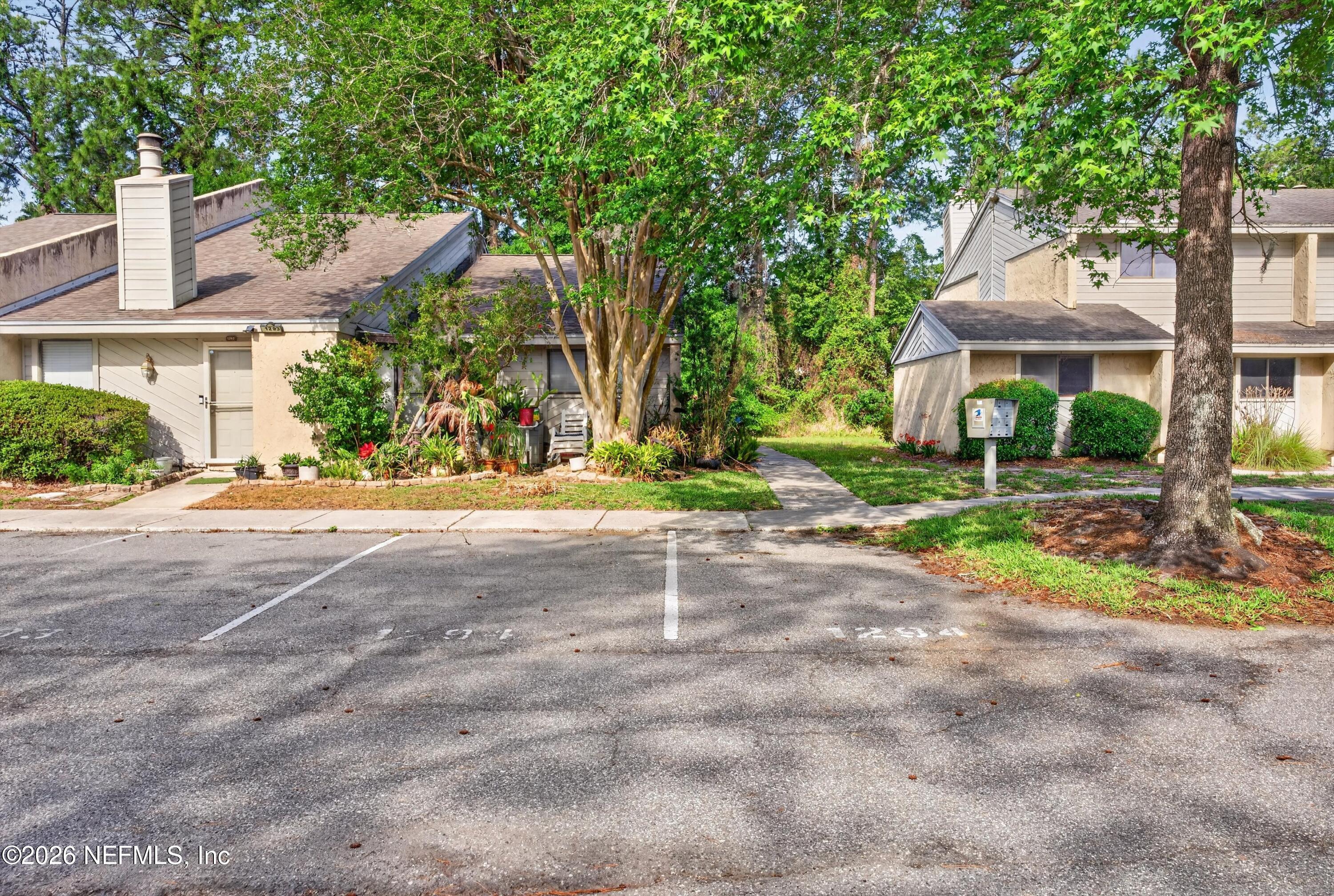 3801 Crown Point Road, Unit 1294 Jacksonville, FL 32257 - Photo 21 of 21 a view of a house with a yard and large tree