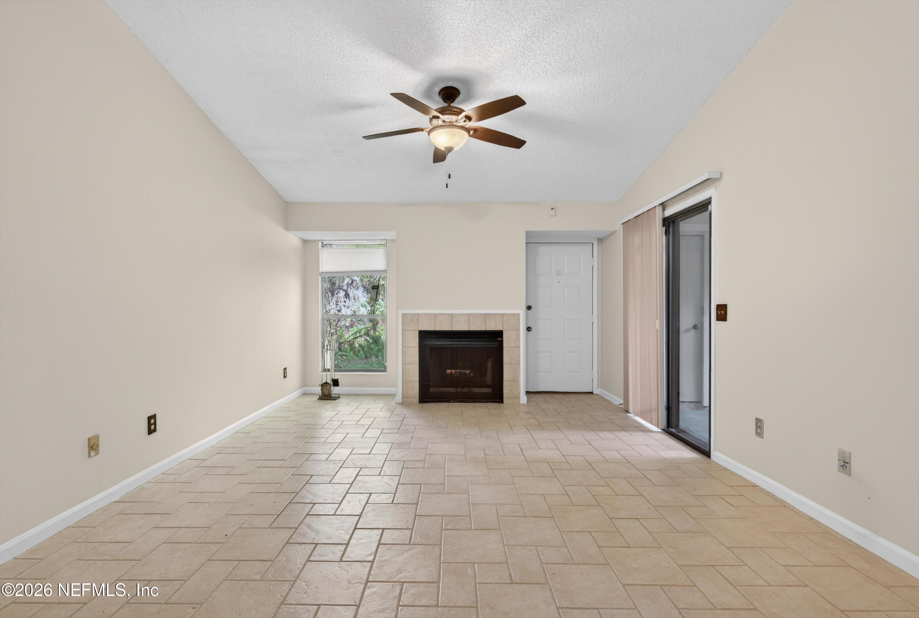 3801 Crown Point Road, Unit 1294 Jacksonville, FL 32257 - Photo 6 of 21 a view of an empty room with a fireplace and a window