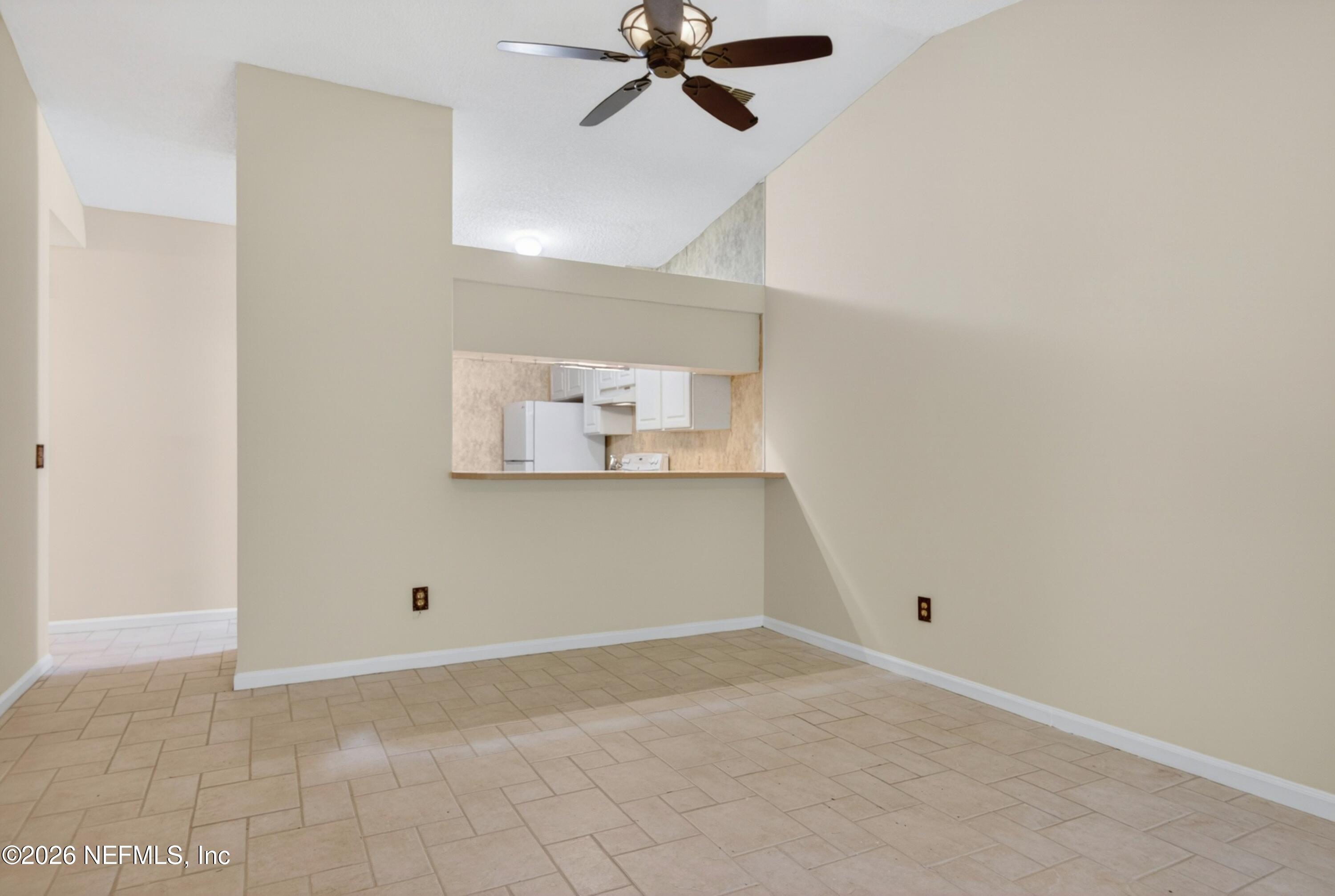 3801 Crown Point Road, Unit 1294 Jacksonville, FL 32257 - Photo 8 of 21 an empty room with a ceiling fan and a window