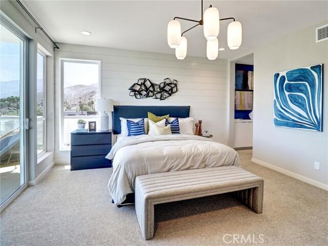 706 Obsidian Loop East Palm Springs, CA 92264 - Photo 21 of 49 a bedroom with a bed and dresser