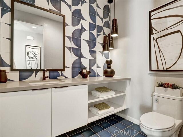 706 Obsidian Loop East Palm Springs, CA 92264 - Photo 24 of 49 a bathroom with a sink a toilet and mirror