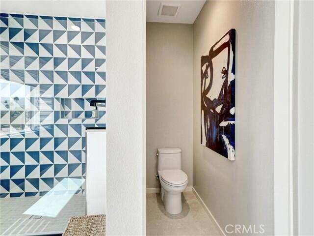 706 Obsidian Loop East Palm Springs, CA 92264 - Photo 25 of 49 a white toilet sitting next to a shower curtain