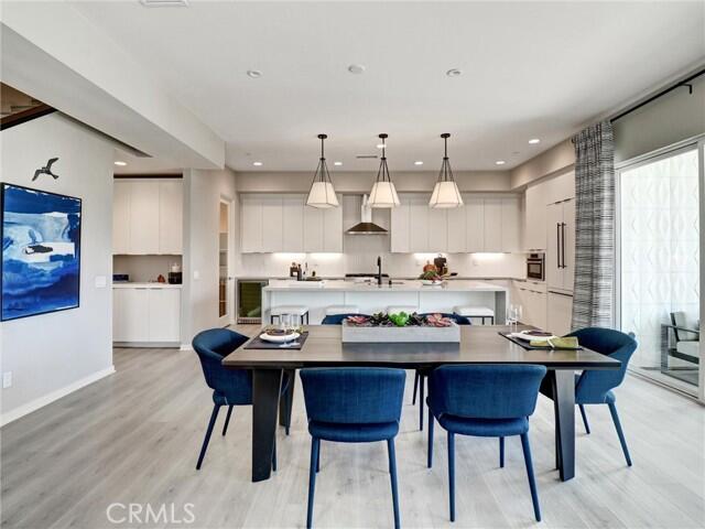 706 Obsidian Loop East Palm Springs, CA 92264 - Photo 4 of 49 a kitchen with stainless steel appliances a dining table and chairs