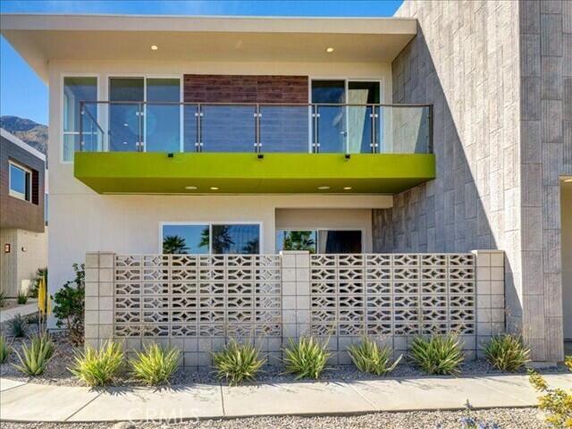 706 Obsidian Loop East Palm Springs, CA 92264 - Photo 47 of 49 a front view of a house with a garden