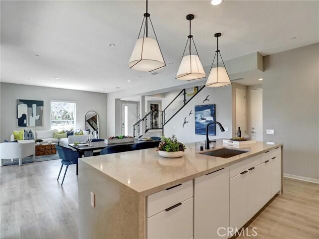 706 Obsidian Loop East Palm Springs, CA 92264 - Photo 8 of 49 a kitchen with stainless steel appliances lots of counter space and wooden floor