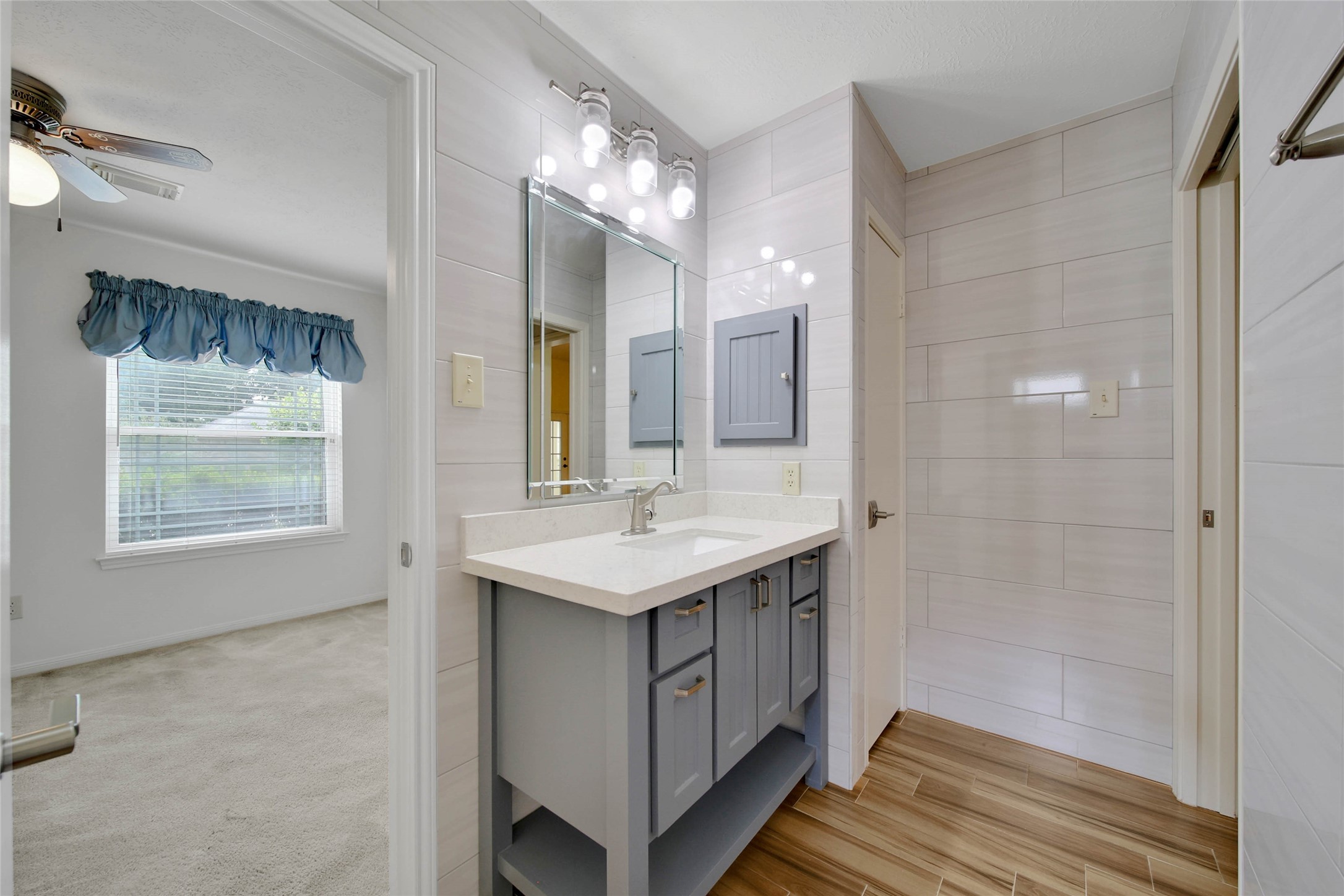 5010 Cupids Bower Court Spring, TX 77388 - Photo 27 of 40 a bathroom with a sink a large mirror and a shower
