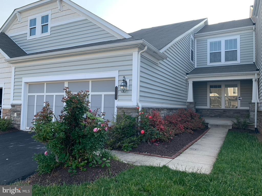 23553 Christina Ridge Square Ashburn, VA 20148 - Photo 1 of 26 a front view of a house with garden