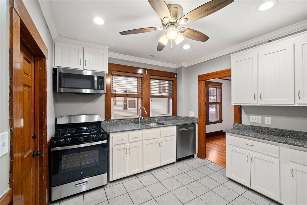 86-88 Maple Avenue North Andover, MA 01845 - Photo 11 of 41 a kitchen with stainless steel appliances white cabinets and a stove top oven