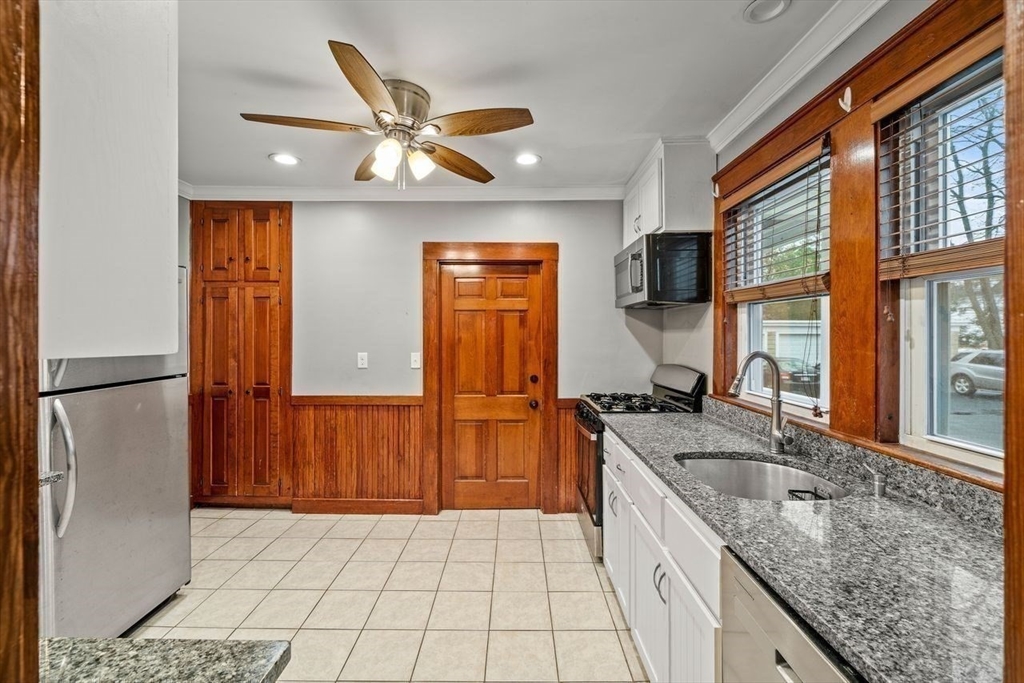 86-88 Maple Avenue North Andover, MA 01845 - Photo 12 of 41 a kitchen with stainless steel appliances granite countertop a sink and a refrigerator