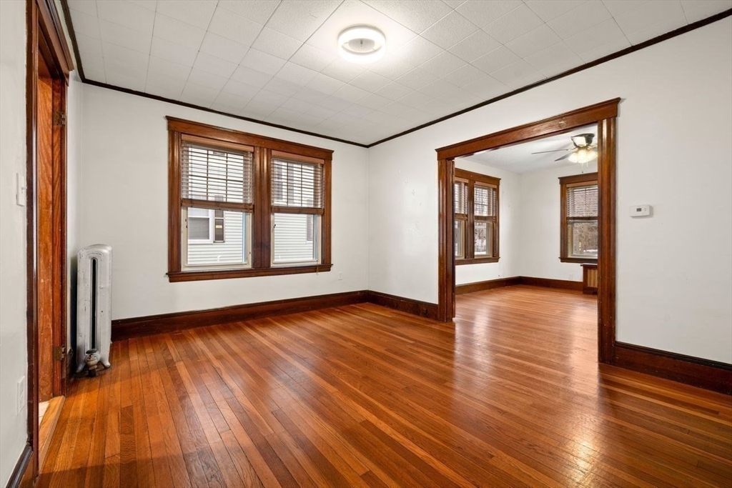 86-88 Maple Avenue North Andover, MA 01845 - Photo 13 of 41 a view of an empty room with wooden floor and a window