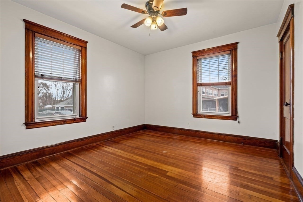 86-88 Maple Avenue North Andover, MA 01845 - Photo 17 of 41 a view of an empty room with window and wooden floor