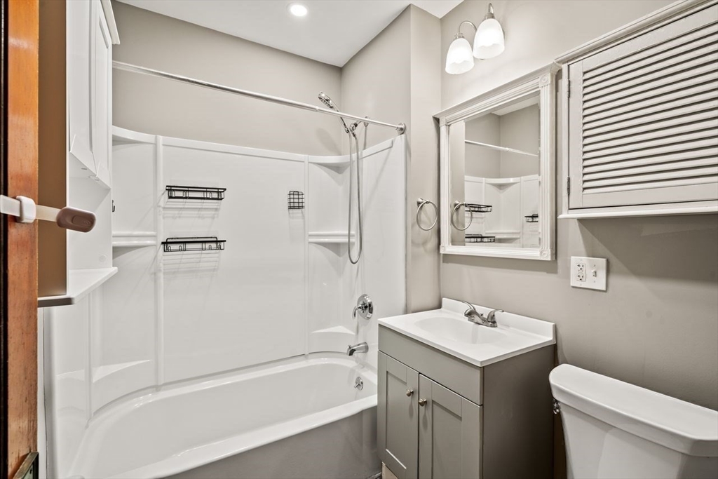 86-88 Maple Avenue North Andover, MA 01845 - Photo 20 of 41 a bathroom with a granite countertop sink toilet and shower