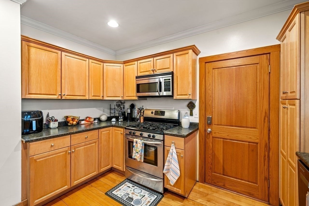 86-88 Maple Avenue North Andover, MA 01845 - Photo 22 of 41 a kitchen with granite countertop stainless steel appliances a stove top oven