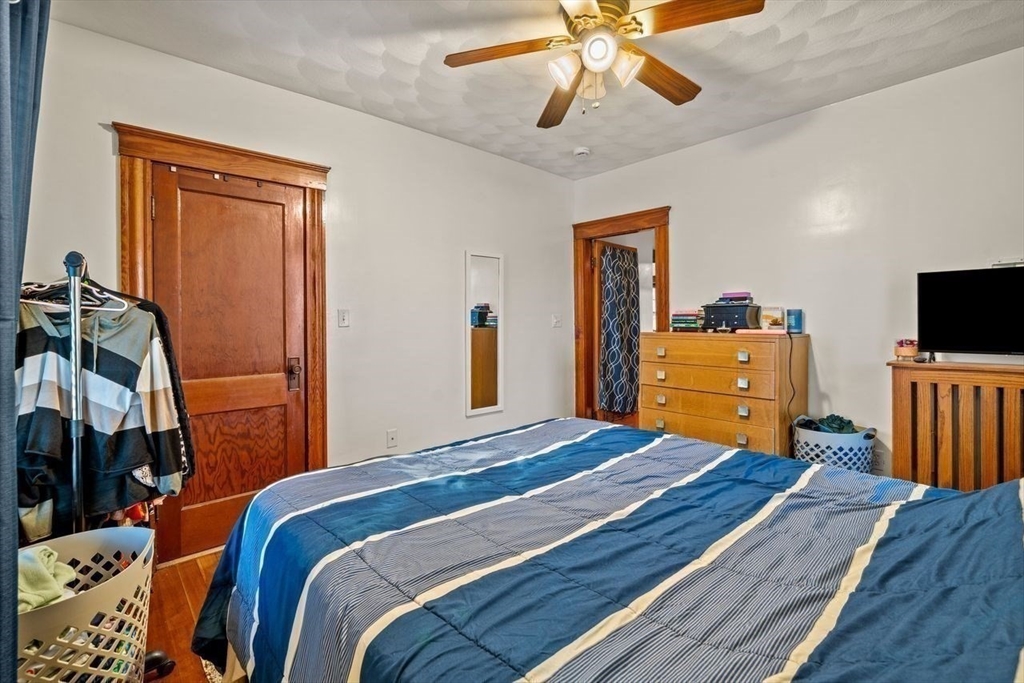 86-88 Maple Avenue North Andover, MA 01845 - Photo 28 of 41 a bedroom with a bed and wooden floor
