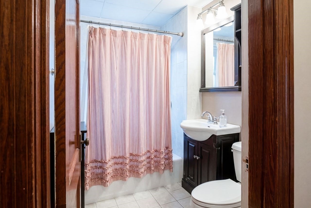 86-88 Maple Avenue North Andover, MA 01845 - Photo 31 of 41 a bathroom with a sink a toilet and shower curtain