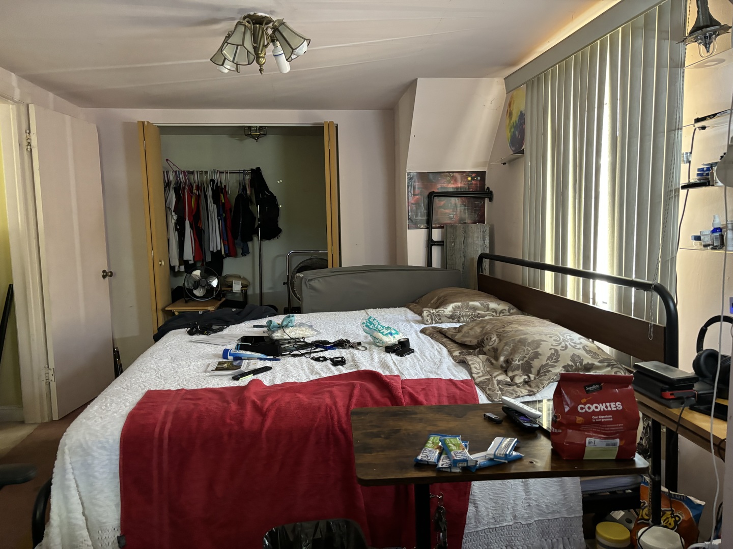 545 East 86th Street Chicago, IL 60619 - Photo 12 of 22 a bedroom with a bed and a chandelier