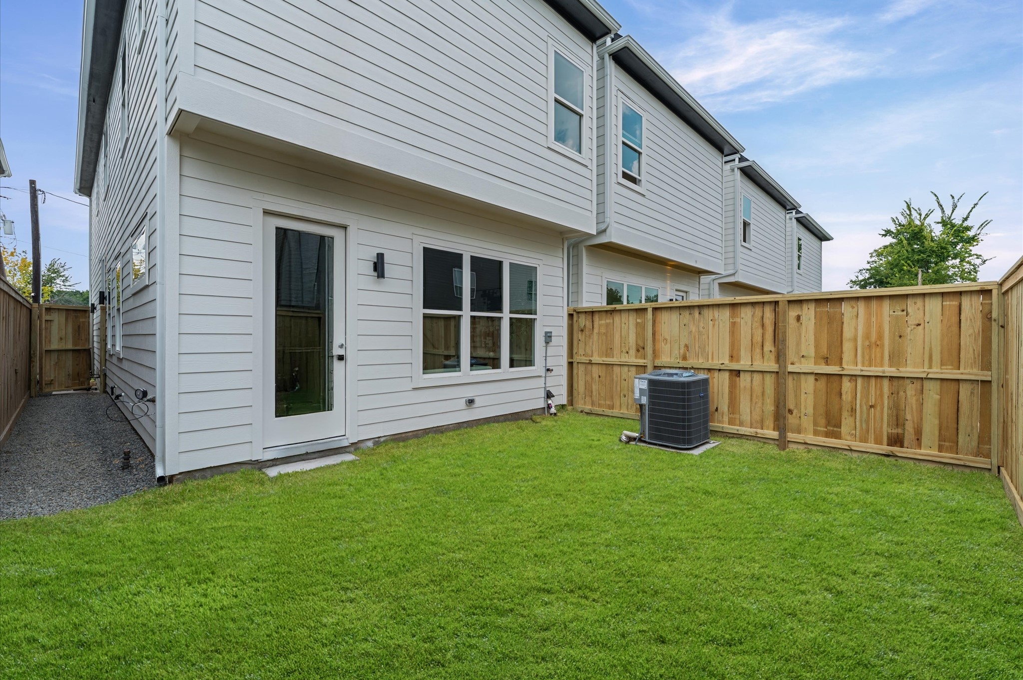 6423 Madrid Street Houston, TX 77021 - Photo 2 of 25 a view of backyard with wooden fence and a large tree