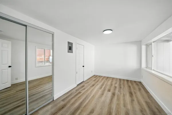 a view of a room with wooden floor and window