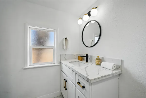 a bathroom with a sink and a mirror
