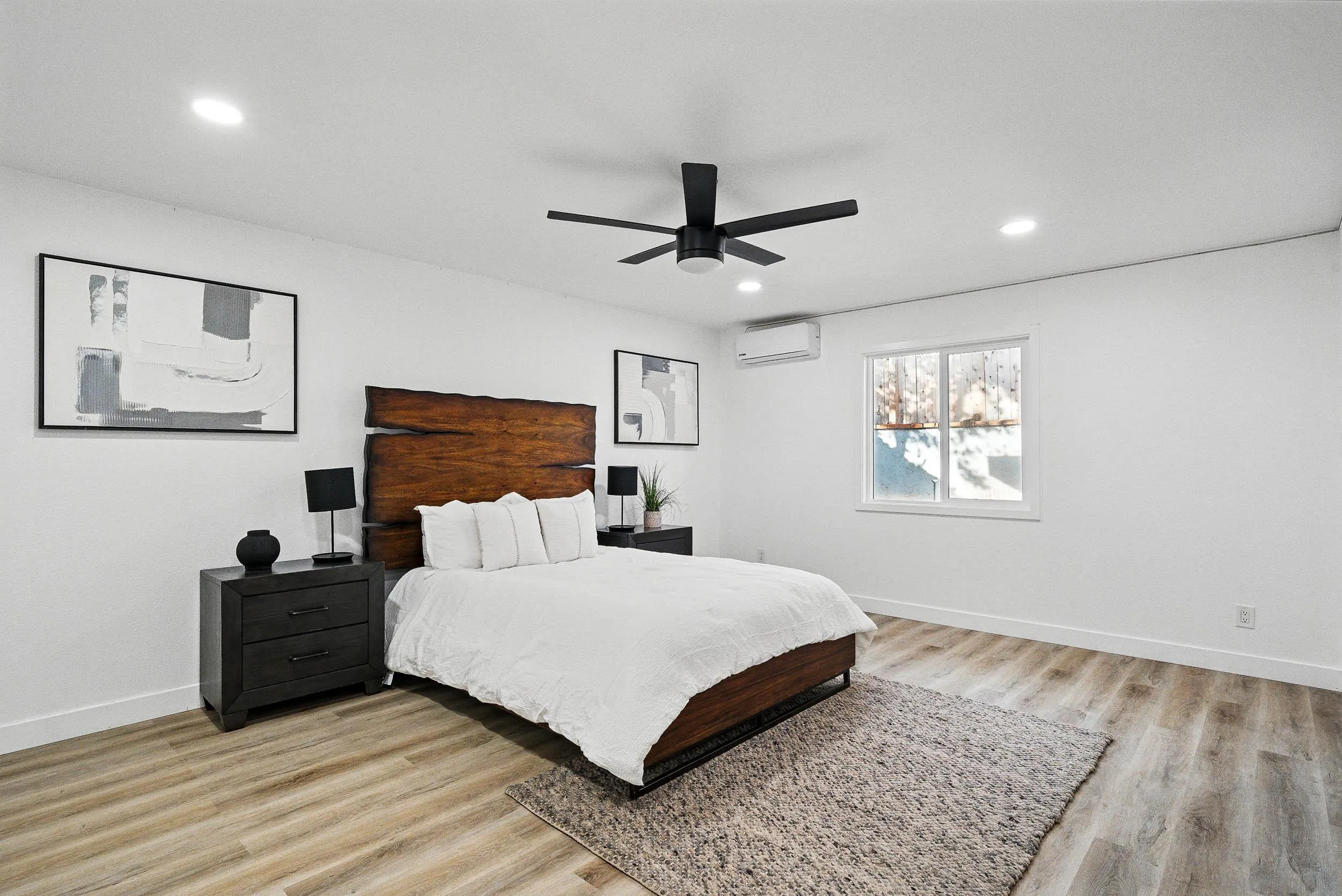 12049 Coping Place Lakeside, CA 92040 - Photo 18 of 36 a bedroom with a large bed chandelier and a window