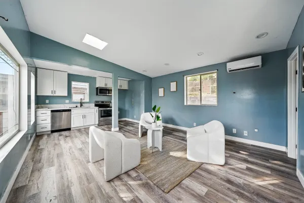 a living room with furniture and kitchen view