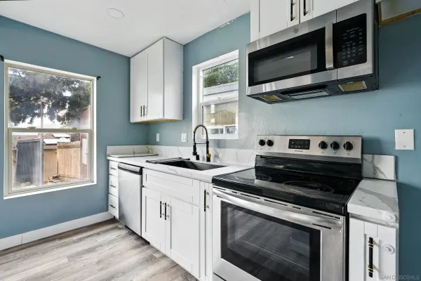 a kitchen with stainless steel appliances a stove a microwave and cabinets