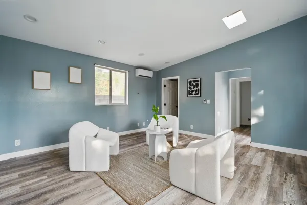 a living room with couches and painting on the wall