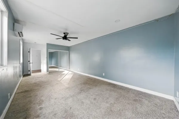 a view of a livingroom with a ceiling fan and window