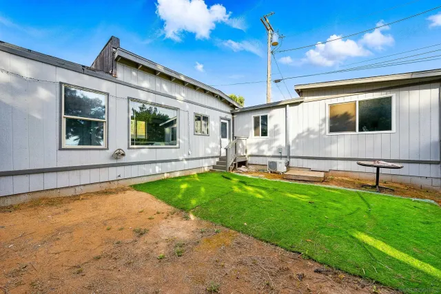 a view of house with swimming pool outdoor seating