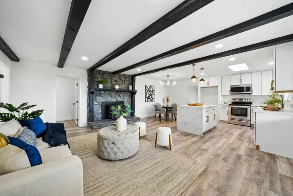 a living room with furniture fireplace and wooden floor