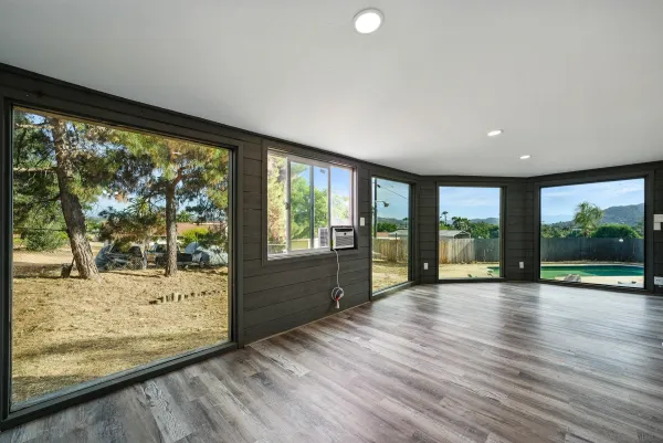 a view of room with window and wooden floor