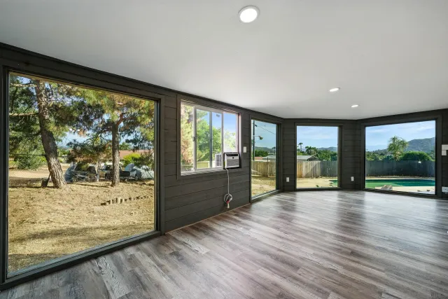 a view of room with window and wooden floor