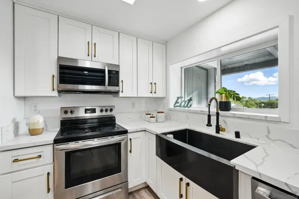 a kitchen with a sink stove and microwave