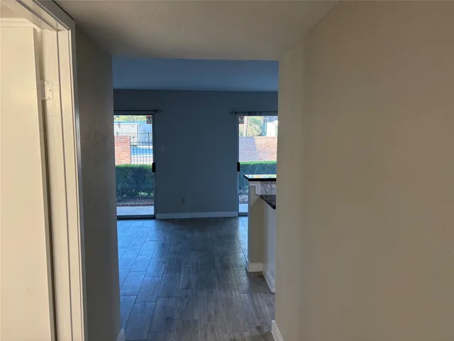 a view of hallway with wooden floor