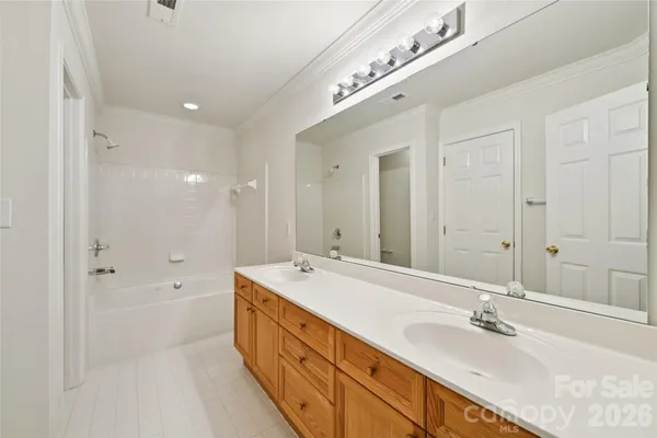 an empty room with a ceiling fan and a window