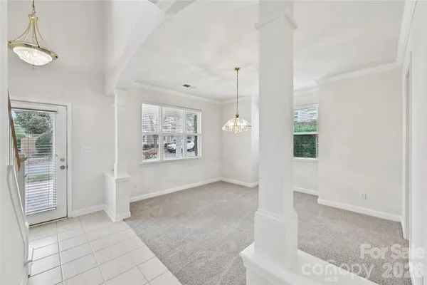 an empty room with a window and a ceiling fan