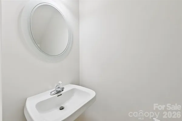 a bathroom with a granite countertop shower sink and mirror