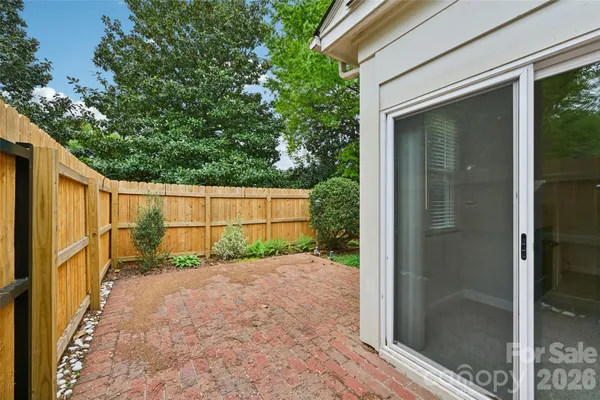 a view of a house with a yard and potted plants