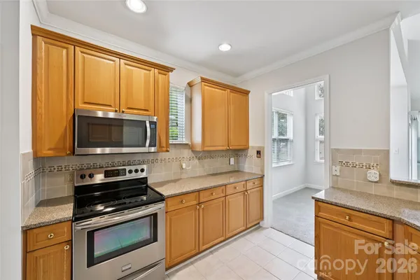 a kitchen with a stove a sink and a microwave