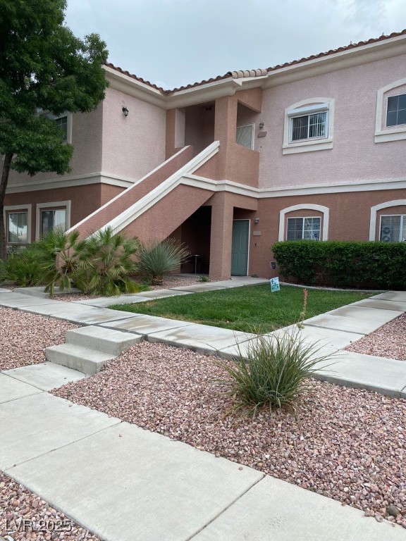 10525 Autumn Pine Avenue, Unit 205 Las Vegas, NV 89144 - Photo 1 of 8 View of front of property with stucco siding, a tiled roof, and a balcony
