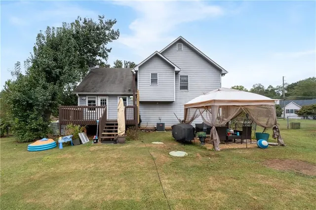 a view of a house with a yard and sitting area