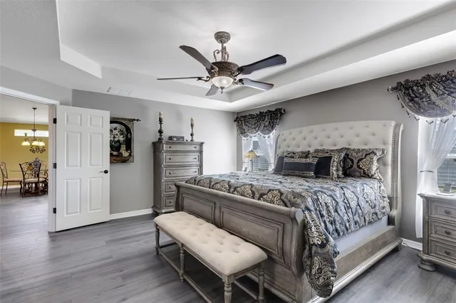 a bedroom with a bed and a chandelier