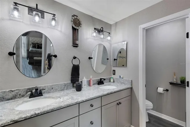 a bathroom with a double vanity sink and a mirror