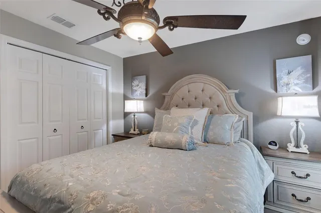 a large bed sitting in a bedroom and chandelier